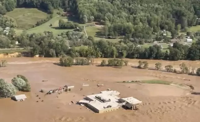 This image taken from video from the Tennessee Emergency Management Agency shows a helicopter on the roof of Unicoi County Hospital in Erwin, Tenn., where patients and staff had to be rescued from after the Nolichucky River flooded and surrounded the building from Hurricane Helene, Friday, Sept. 27, 2024. (Tennessee Emergency Management Agency via AP)