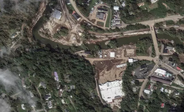 This satellite image released by Maxar Technologies shows flooding by the North Toe River and market damage from Hurricane Helene in Spruce Pine, N.C., Wednesday, Oct. 2, 2024. (Satellite image ©2024 Maxar Technologies via AP)