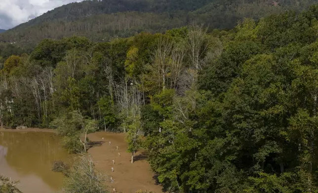 Search crews look for victims in the aftermath of Hurricane Helene, Tuesday, Oct. 1, 2024, in Swannanoa, N.C. (AP Photo/Mike Stewart)