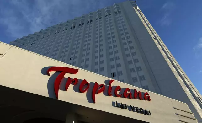 FILE - Sunlight illuminates a sign at the Tropicana hotel and casino on Aug. 4, 2015, in Las Vegas. (AP Photo/John Locher, File)