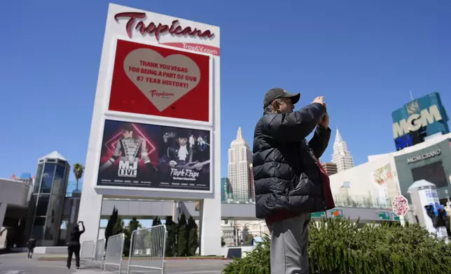 FILE - People take pictures before the closing of the Tropicana hotel-casino, Tuesday, April 2, 2024, in Las Vegas. (AP Photo/John Locher, File)