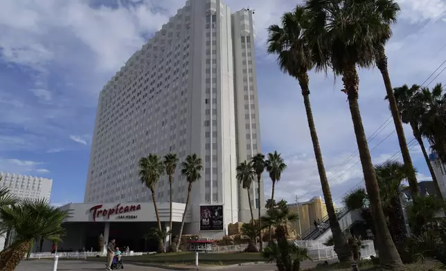 FILE - People stand outside of the Tropicana Las Vegas, Tuesday, May 16, 2023, in Las Vegas. (AP Photo/John Locher, File)