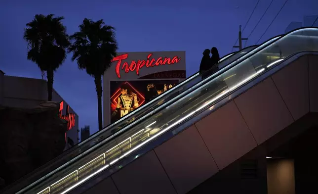 FILE - People ride an escalator outside of the Tropicana hotel-casino Thursday, March 28, 2024, in Las Vegas. (AP Photo/John Locher, File)