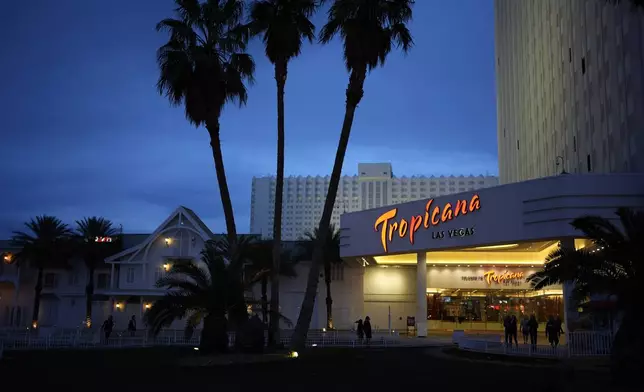 FILE - People walk outside of the Tropicana hotel-casino Thursday, March 28, 2024, in Las Vegas. (AP Photo/John Locher, File)