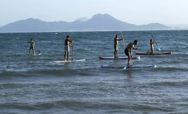 People paddle board in the Mediterranean Sea at Sidi Bousaid beach, in Tunis, Tunisia, Tuesday, Oct. 1, 2024 (AP Photo/Anis Mili)