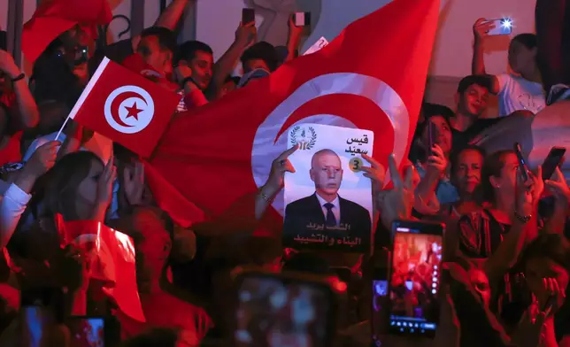 Supporters of Tunisian president and candidate for re-election Kais Saied celebrate after the announcement of the provisional results for the presidential elections, in the capital Tunis, Tunisia, Sunday, Oct. 6, 2024. (AP Photo/Anis Mili)