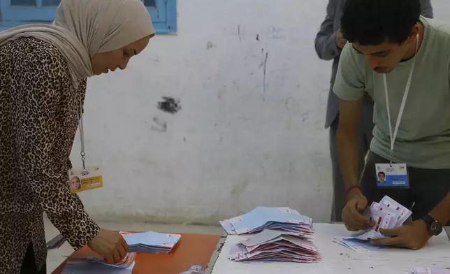 Election officials count the votes after the presidential elections in the capital Tunis, Tunisia, Sunday, Oct. 6, 2024. (AP Photo/Anis Mili)