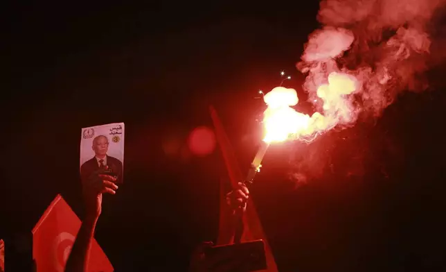 Supporters of Tunisian president and candidate for re-election Kais Saied celebrate after the announcement of the provisional results for the presidential elections, in the capital Tunis, Tunisia, Sunday, Oct. 6, 2024. (AP Photo/Anis Mili)