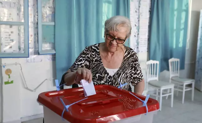 A Tunisian voter casts her ballot at a polling station during the presidential elections, in the capital Tunis, Tunisia, Sunday, Oct. 6, 2024. (AP Photo/Anis Mili)