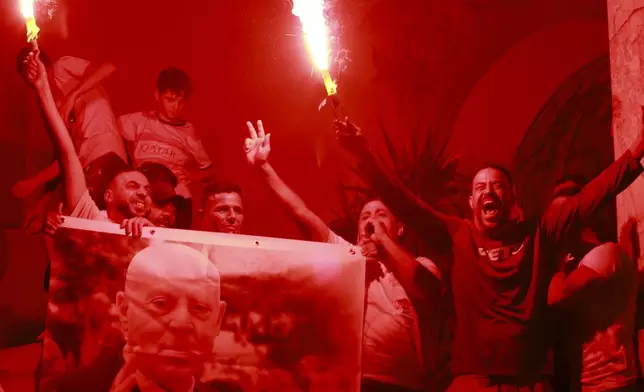 Supporters of Tunisian president and candidate for re-election Kais Saied celebrate after the announcement of the provisional results for the presidential elections, in the capital Tunis, Tunisia, Sunday, Oct. 6, 2024. (AP Photo/Anis Mili)