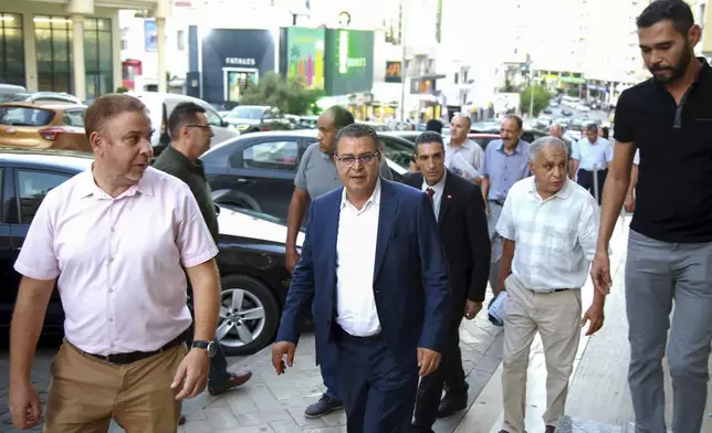 Tunisian presidential candidate Zouhair El Maghzaoui, meets with residents of a neighbourhood during his campaign tour, ahead of the upcoming presidential elections, in Tunis, Tunisia, Thursday, Sept. 26, 2024. (AP Photo/Anis Mili)