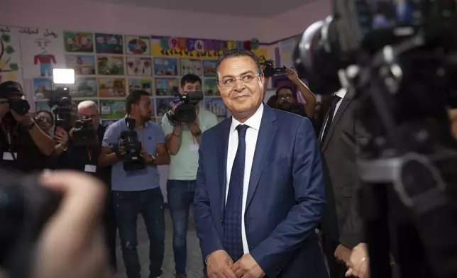 Tunisian President Presidential candidate Zouhair Maghzaoui prepares to cast his vote at a polling station during the presidential elections, in the capital Tunis, Tunisia, Sunday, Oct. 6, 2024. (AP Photo/Ons Abid)