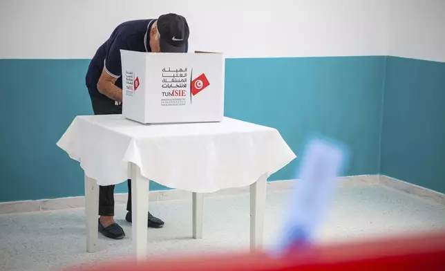 A voter casts his ballot at a polling station during the presidential elections, in the capital Tunis, Tunisia, Sunday, Oct. 6, 2024 (AP Photo/Ons Abid)