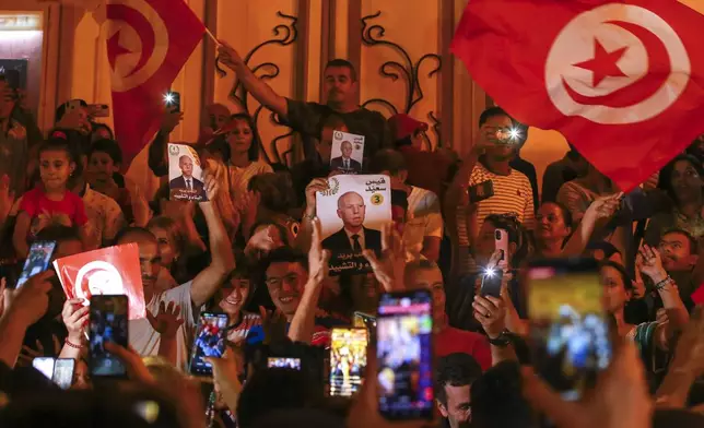 Supporters of Tunisian president and candidate for re-election Kais Saied celebrate after the announcement of the provisional results for the presidential elections, in the capital Tunis, Tunisia, Sunday, Oct. 6, 2024. (AP Photo/Anis Mili)