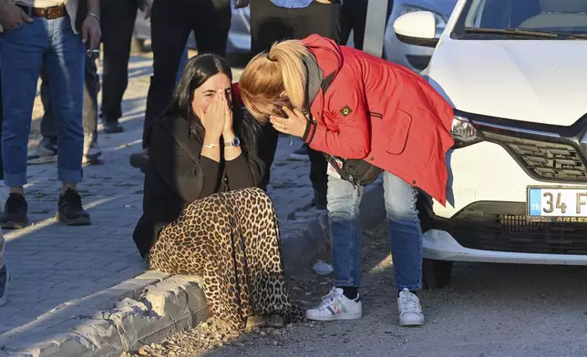 People gather outside of Turkish Aerospace Industries Inc. at the outskirts of Ankara, Turkey, Wednesday, Oct. 23, 2024. (AP Photo)