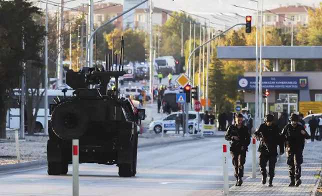 Emergency and security teams are deployed outside the Turkish state-run aerospace and defense company Turkish Aerospace Industries Inc. on the outskirts of Ankara, Turkey, Wednesday, Oct. 23, 2024. (Yavuz Ozden/Dia Photo via AP)