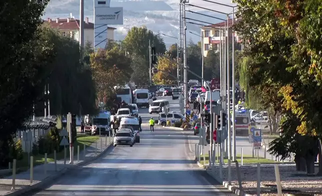 Emergency rescue teams and police officers work outside of Turkish Aerospace Industries Inc. on the outskirts of Ankara, Turkey, Wednesday, Oct. 23, 2024. (IHA via AP)