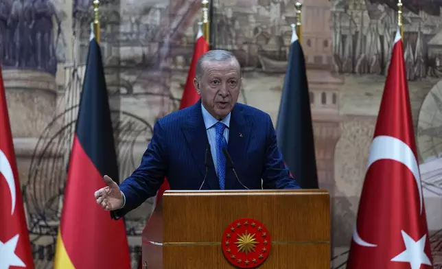 Turkey's President Recep Tayyip Erdogan, right, answers journalists questions during a presser with Germany's Chancellor Olaf Scholz, in Istanbul, Turkey, Saturday, Oct. 19, 2024. (AP Photo/Khalil Hamra)