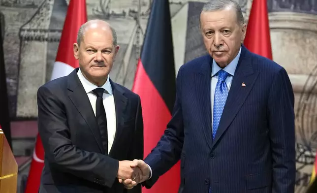 Turkey's President Recep Tayyip Erdogan, right, shakes hands with Germany's Chancellor Olaf Scholz, following a press conference in Istanbul, Turkey, Saturday, Oct. 19, 2024. (AP Photo/Khalil Hamra)