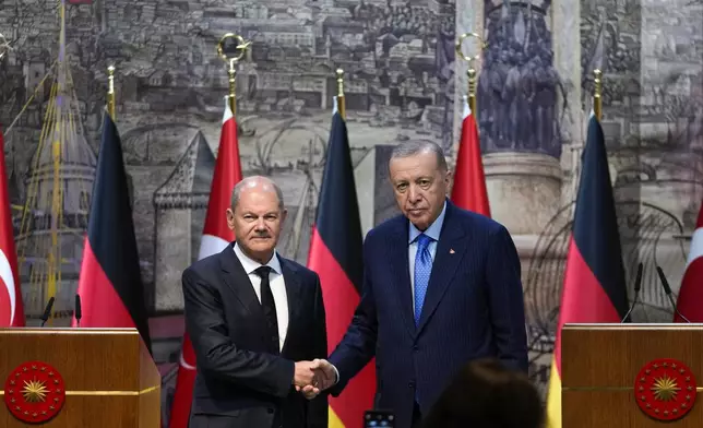 Turkey's President Recep Tayyip Erdogan, right, shakes hands with Germany's Chancellor Olaf Scholz, following a press conference in Istanbul, Turkey, Saturday, Oct. 19, 2024. (AP Photo/Khalil Hamra)