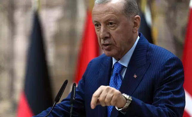 Turkey's President Recep Tayyip Erdogan, right, answers journalists' questions during a presser with Germany's Chancellor Olaf Scholz, in Istanbul, Turkey, Saturday, Oct. 19, 2024. (AP Photo/Khalil Hamra)