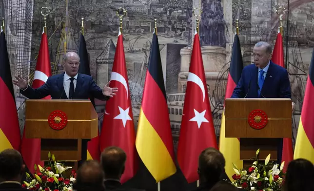 Turkey's President Recep Tayyip Erdogan, right, and Germany's Chancellor Olaf Scholz, answer journalists questions hold a presser in Istanbul, Turkey, Saturday, Oct. 19, 2024. (AP Photo/Khalil Hamra)