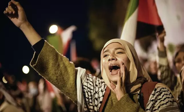 A woman chants slogans during a pro-Palestinian protest next to the U.S. Consulate in Istanbul, Turkey, Friday, Oct. 25, 2024. (AP Photo/Emrah Gurel)