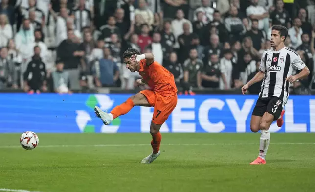 Eintracht Frankfurt's Omar Marmoush, left, attempts a shot at goal next to Besiktas' Gabriel Paulista during the Europa League opening phase soccer match between Besiktas and Eintracht Frankfurt at the Besiktas stadium in Istanbul, Turkey, Thursday, Oct. 3, 2024. (AP Photo/Khalil Hamra)