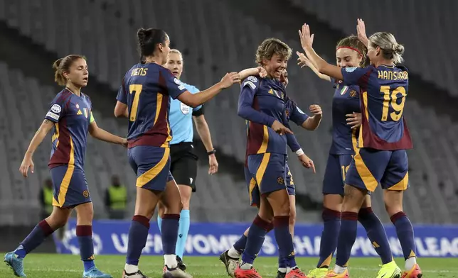 Roma's Valentina Giacinti, center, celebrates with teammates after scoring their side's second goal during the women's Champions League group A soccer match between Galatasaray and Roma at Ataturk Olympic stadium in Istanbul, Turkey, Thursday, Oct. 17, 2024. (Huseyin Yavuz/Dia Photo via AP)