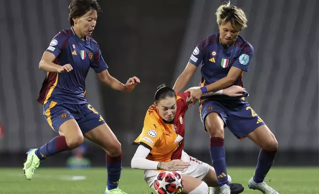 Galatasaray's Andrea Staskova, center, fights for the ball with Roma's Saki Kumagai, left, and Moeka Minami during the women's Champions League group A soccer match between Galatasaray and Roma at Ataturk Olympic stadium in Istanbul, Turkey, Thursday, Oct. 17, 2024. (Huseyin Yavuz/Dia Photo via AP)