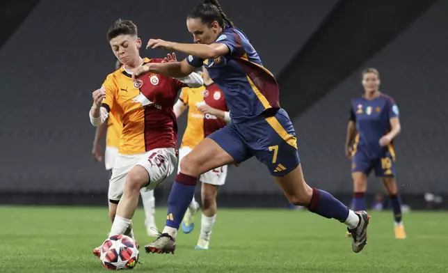 Galatasaray's Kristina Bakarandze, left, vies for the ball with Roma's Evelyne Viens during the women's Champions League group A soccer match between Galatasaray and Roma at Ataturk Olympic stadium in Istanbul, Turkey, Thursday, Oct. 17, 2024. (Huseyin Yavuz/Dia Photo via AP)