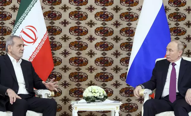 Russian President Vladimir Putin, right, listens to Iranian President Masoud Pezeshkian during their meeting on the sidelines of the International Forum "The Interconnection of Times and Civilizations – the basis of peace and development" dedicated to the 300th anniversary of the birth of the outstanding Turkmen poet and thinker Magtymguly Fragi in Ashgabat, Turkmenistan, Friday, Oct. 11, 2024. (Alexander Shcherbak, Sputnik, Kremlin Pool Photo via AP)