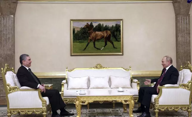 Russian President Vladimir Putin, right, and Chairman of the People's Council of Turkmenistan Gurbanguly Berdymukhamedov talk to each other during their meeting on the sidelines of the International Forum "The Interconnection of Times and Civilizations – the basis of peace and development" dedicated to the 300th anniversary of the birth of the outstanding Turkmen poet and thinker Magtymguly Fragi in Ashgabat, Turkmenistan, Friday, Oct. 11, 2024. (Gavriil Grigorov, Sputnik, Kremlin Pool Photo via AP)