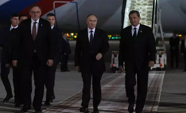 Russian President Vladimir Putin, 2nd right, is greeted by Turkmen Foreign Minister Rashid Meredov, right, upon his arrival in Ashgabat, Turkmenistan, Friday, Oct. 11, 2024. (Alexander Shcherbak, Sputnik, Kremlin Pool Photo via AP)