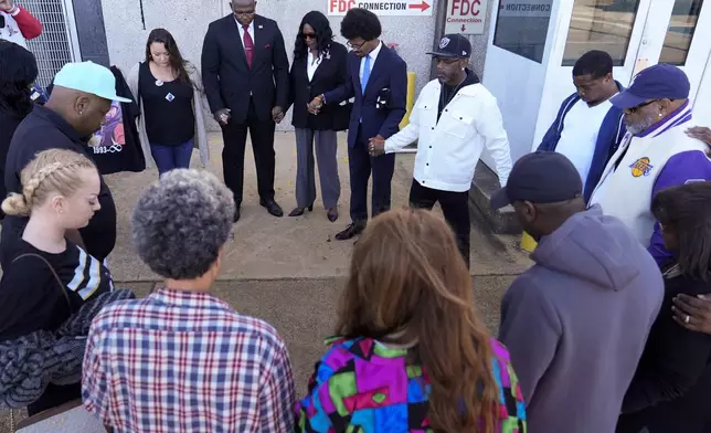 Family and friends of Tyre Nichols, pray before entering the federal courthouse for the trial of three former Memphis police officers charged in the 2023 fatal beating of Nichols, Wednesday, Oct. 2, 2024, in Memphis, Tenn. (AP Photo/George Walker IV)