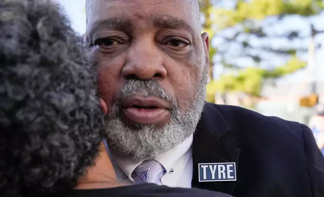 Rodney Wells, stepfather of Tyre Nichols receives a hug from a supporter as he leaves the federal courthouse after three former Memphis police officers were convicted of witness tampering charges in the 2023 fatal beating of his stepson Tyre, Thursday, Oct. 3, 2024, in Memphis, Tenn. (AP Photo/George Walker IV)