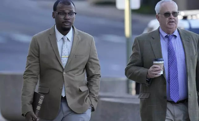 Justin Smith, left, one of three former Memphis police officers charged in the 2023 fatal beating of Tyre Nichols, arrives at the federal courthouse with his attorney Martin Zummach, right, for the day's proceedings Thursday, Oct. 3, 2024, in Memphis, Tenn. (AP Photo/George Walker IV)