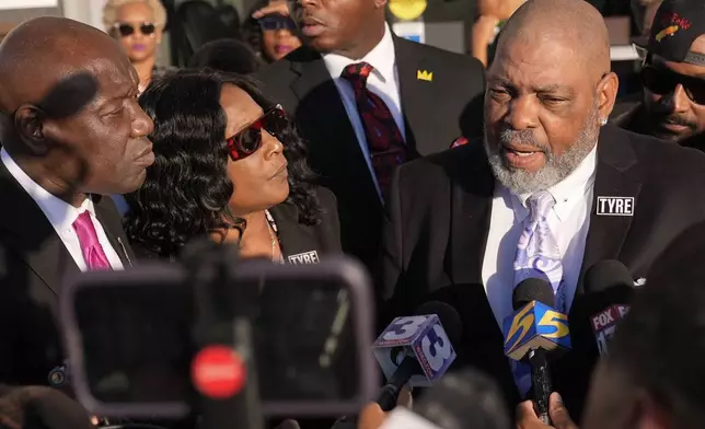 Rodney Wells, right, stepfather of Tyre Nichols, speaks during a news conference with his wife RowVaughn Wells, center, and attorney Ben Crump, left, outside the federal courthouse after three former Memphis police officers were convicted of witness tampering charges in the 2023 fatal beating of their son Nichols, Thursday, Oct. 3, 2024, in Memphis, Tenn. (AP Photo/George Walker IV)