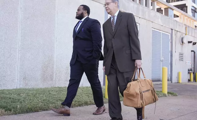 Demetrius Haley, left, one of three former Memphis police officers charged in the 2023 fatal beating of Tyre Nichols, arrives at the federal courthouse with his attorney Michael Stengel, right, for the day's proceedings Thursday, Oct. 3, 2024, in Memphis, Tenn. (AP Photo/George Walker IV)