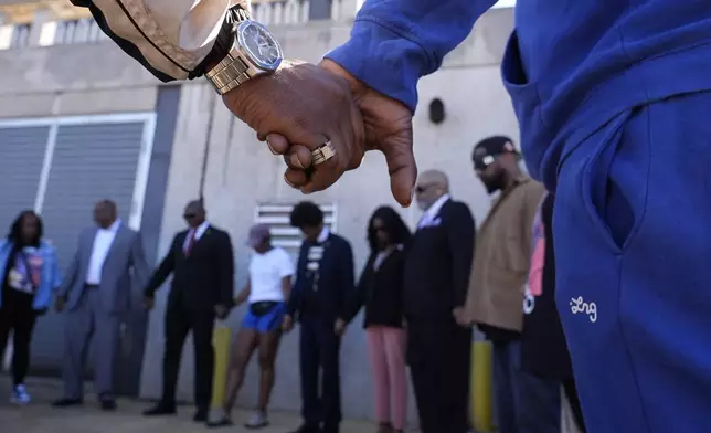 Family and friends of Tyre Nichols gather for a prayer vigil outside the federal courthouse as jury deliberations begin for the trial of three former Memphis police officers charged in the 2023 fatal beating of Nichols, Thursday, Oct. 3, 2024, in Memphis, Tenn. (AP Photo/George Walker IV)