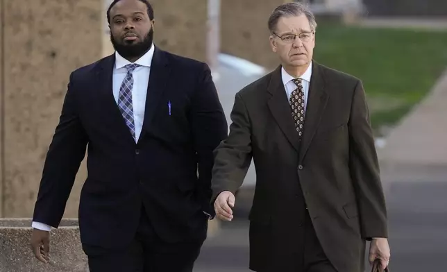 Demetrius Haley, left, one of three former Memphis police officers charged in the 2023 fatal beating of Tyre Nichols, arrives at the federal courthouse with his attorney Michael Stengel, right, for the day's proceedings Thursday, Oct. 3, 2024, in Memphis, Tenn. (AP Photo/George Walker IV)