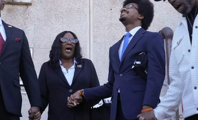 RowVaughn Wells, left, mother of Tyre Nichols, shouts her son's name with Rep. Justin J. Pearson, D-Memphis, second from right, before entering the federal courthouse for the trial of three former Memphis police officers charged in the 2023 fatal beating of her son Wednesday, Oct. 2, 2024, in Memphis, Tenn. (AP Photo/George Walker IV)