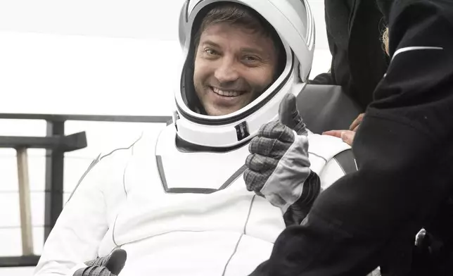 This photo provided by NASA shows NASA astronaut Matthew Dominick being helped out of the SpaceX Dragon Endeavour spacecraft onboard the SpaceX recovery ship MEGAN after he, NASA astronauts Michael Barratt, Jeanette Epps, and Roscosmos cosmonaut Alexander Grebenkin landed, in the Gulf of Mexico off the coast of Pensacola, Florida, Friday, Oct. 25, 2024. (NASA/Joel Kowsky via AP)