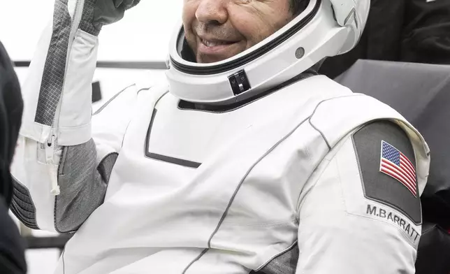 This photo provided by NASA shows NASA astronaut Michael Barratt being helped out of the SpaceX Dragon Endeavour spacecraft onboard the SpaceX recovery ship MEGAN after he, NASA astronauts Matthew Dominick, Jeanette Epps, and Roscosmos cosmonaut Alexander Grebenkin landed, in the Gulf of Mexico off the coast of Pensacola, Florida, Friday, Oct. 25, 2024. (NASA/Joel Kowsky via AP)