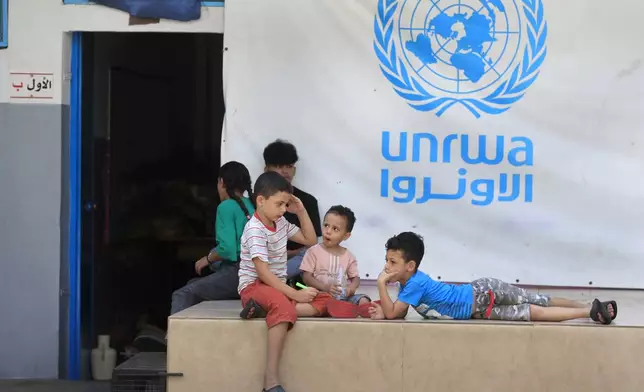 FILE - Palestinian children who fled with their parents from their houses in the Palestinian refugee camp of Ein el-Hilweh, gather in the backyard of an UNRWA school, in Sidon, Lebanon, Sept. 12, 2023. (AP Photo/Mohammed Zaatari, File)