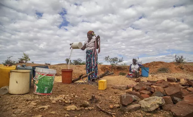 File — Villagers fetch water from a makeshift borehole in Mudzi, Zimbabwe, Tuesday, July 2, 2024. as the United Nations' food agency says months of drought in southern Africa, triggered by the El Nino weather phenomenon, has had a devastating impact on more than 27 million people and caused the region's worst hunger crisis in decades. (AP Photo/Aaron Ufumeli/File)