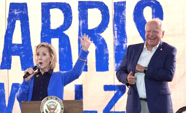 FILE - Democratic vice presidential nominee Minnesota Gov. Tim Walz, right, listens as his wife Gwen Walz speaks at a campaign event, Aug. 18, 2024, in Rochester, Pa. (AP Photo/Julia Nikhinson, File)