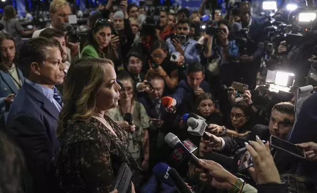 FILE - Olivia Troye, second from the left, and Anthony Scaramucci, left, speak to reporters in the spin room before the presidential debate between Republican presidential nominee former President Donald Trump and Democratic presidential nominee Vice President Kamala Harris, Sept. 10, 2024, in Philadelphia. (AP Photo/Matt Rourke, File)