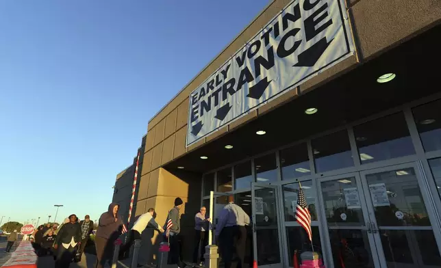 Voters enter the early voting center for the first day of in person early voting at the Franklin County Board of Elections in Columbus, Ohio, Tuesday, Oct. 8, 2024. (AP Photo/Paul Vernon)