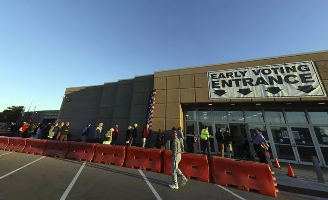 Voters enter the early voting center for the first day of in person early voting at the Franklin County Board of Elections in Columbus, Ohio, Tuesday, Oct. 8, 2024. (AP Photo/Paul Vernon)